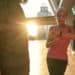 Great results. beautiful and fit middle aged woman in sports clothing looking at smartwatch while training with her husband outdoors