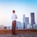 Businessman looking at cityscape with sunlight