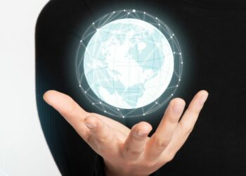 1200 businesswoman holding high technology digitally generated globe
