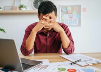 1200 man working with laptop paperwork with stress
