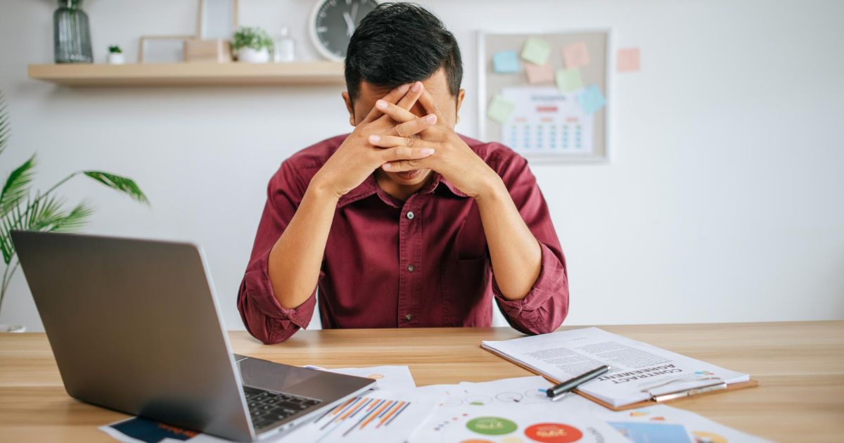 1200 Man Working With Laptop Paperwork With Stress