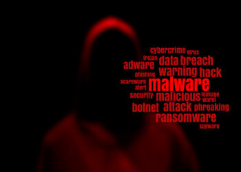 Dark red silhouette of a hacker in a hoodie with malware tag cloud